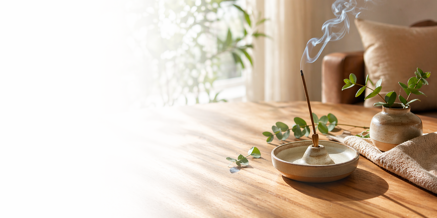 Calm, sunlit home scene with incense and greenery