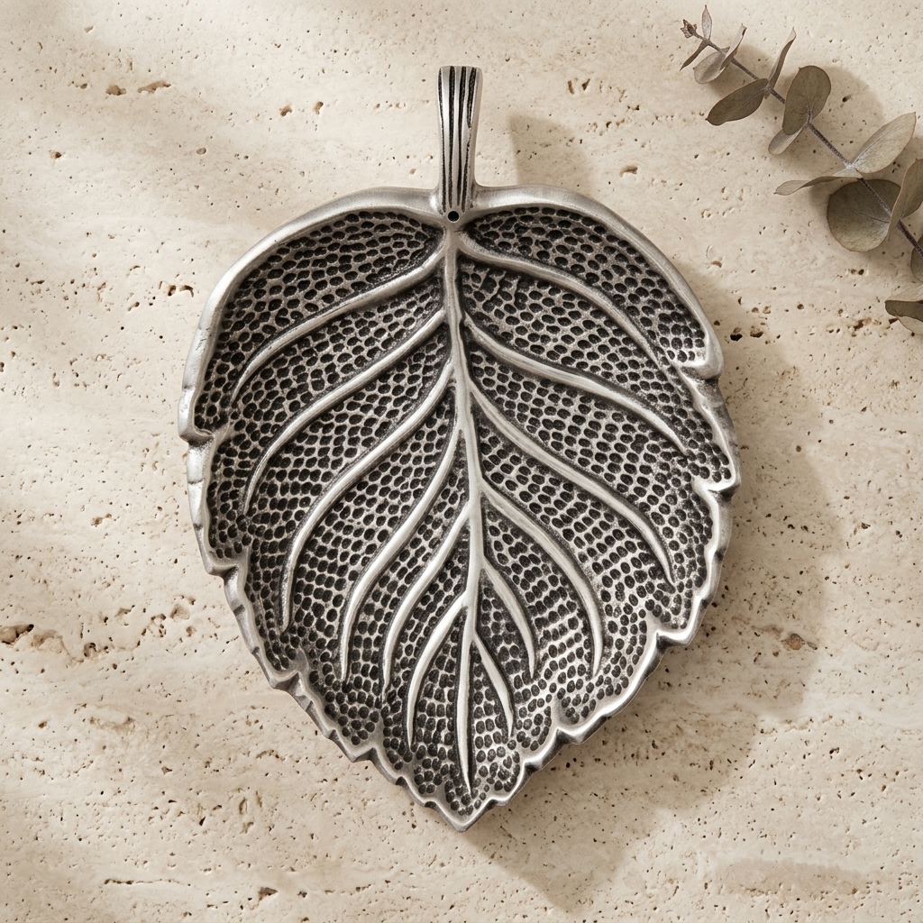 Sacred Leaf Metal Incense Holder on stone showing embossed vein detail