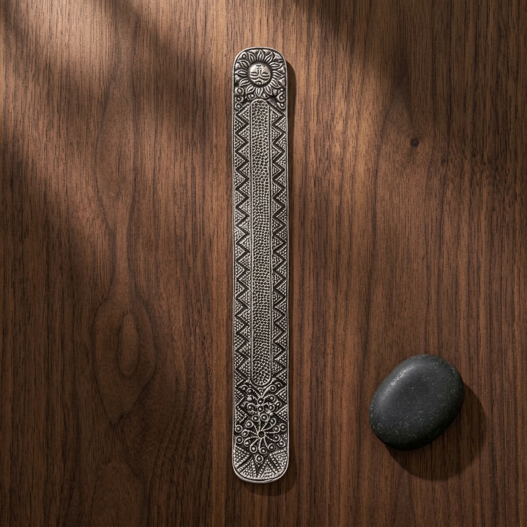 Solaris Metal Incense Holder — Silver overhead on wood with river stone